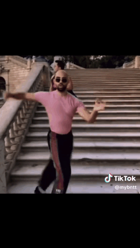 Man In Pink Shirt Dancing On Steps GIF