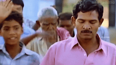 Man In Pink Shirt Eyes Closed In Front Of Crowd GIF