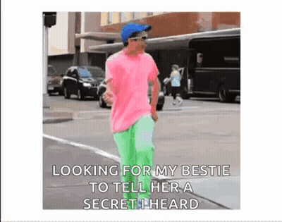 Man In Pink Shirt Green Pants Telling Secret GIF