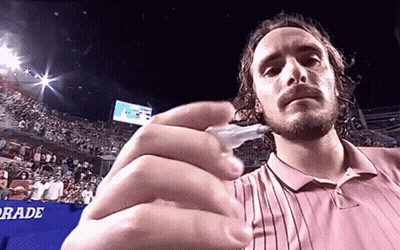 Man In Pink Shirt Holding Pen In Front Of Grade Sign GIF