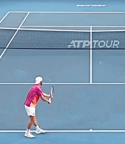 Man In Pink Shirt Holding Tennis Racquet In Crowd GIF