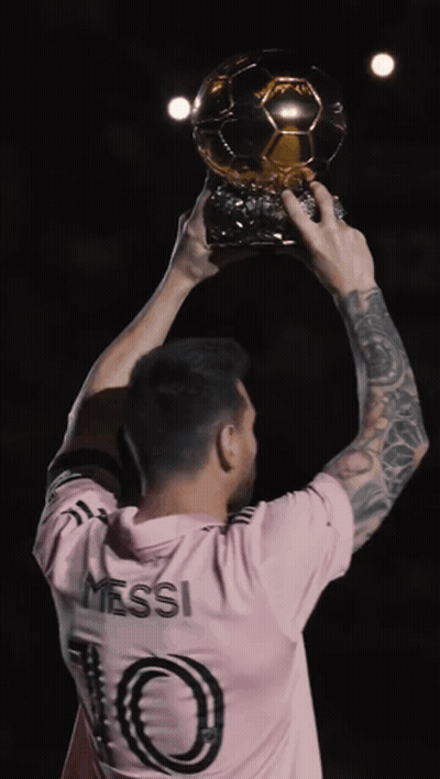 Man In Pink Shirt Holding Trophy GIF