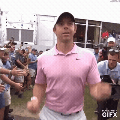 Man In Pink Shirt In Front Of Crowd GIF
