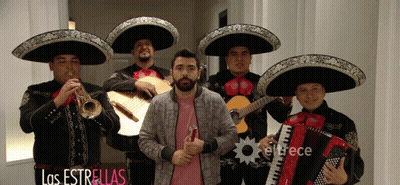 Man In Pink Shirt In Front Of Mariachi Band GIF