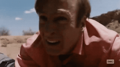 Man In Pink Shirt Laying On Ground Making Face GIF