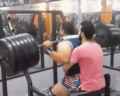 Man In Pink Shirt Lifting Barbell With Onlooker GIF
