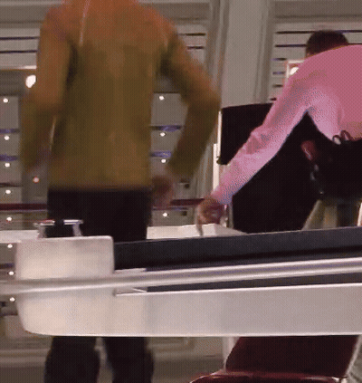 Man In Pink Shirt Next To Woman In Brown Jacket GIF