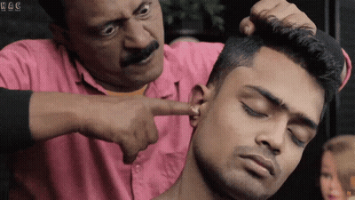 Man In Pink Shirt Pointing At Ear With H & C GIF