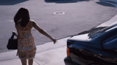 Man In Pink Shirt Running With Woman In Black Sweater GIF