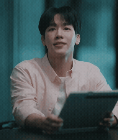 Man In Pink Shirt Sitting At Table With Tablet GIF