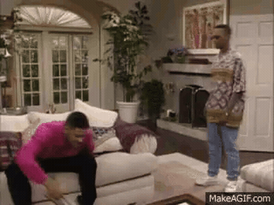 Man In Pink Shirt Sitting On Couch GIF