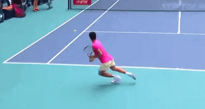 Man In Pink Shirt Stretching Legs On Court GIF