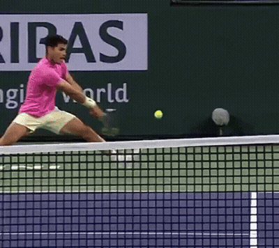 Man In Pink Shirt Swinging Tennis Racquet GIF