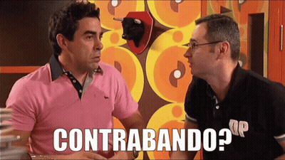 Man In Pink Shirt Talking To Man In Green And Black Striped Sweater GIF