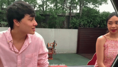 Man In Pink Shirt Talking To Woman In Red GIF
