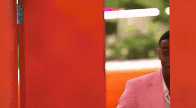 Man In Pink Suit At Red Door GIF