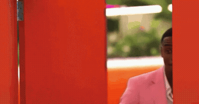 Man In Pink Suit At Red Door GIF