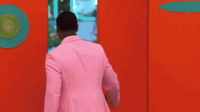 Man In Pink Suit In Doorway GIF