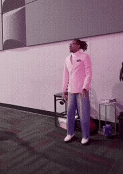 Man In Pink Suit In Front Of Pink Wall GIF
