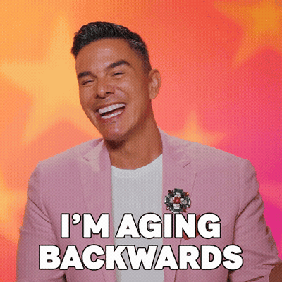 Man In Pink Suit Laughing I'm Aging Backwards GIF