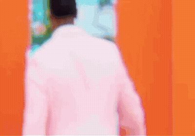 Man In Pink Suit Walking Through Door GIF