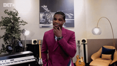 Man In Pink Suit With BET Logo Behind Him GIF