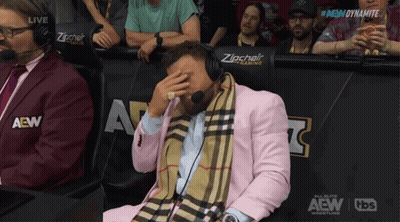 Man In Pink Suit With Zipchair Sign GIF