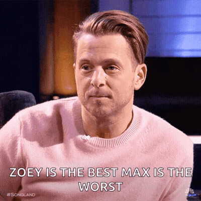 Man In Pink Sweater Saying Zoey Is The Best Max Is The Worst GIF