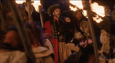 Man In Pirate Costume With Group Holding Torches GIF