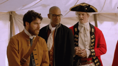 Man In Pirate Hat Next To Historical Costumes GIF