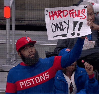 Man In Pistons Shirt Holding Sign GIF