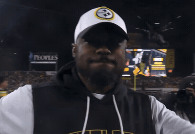Man In Pittsburgh Hat In Front Of Large Screen GIF
