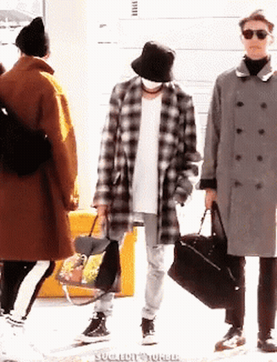 Man In Plaid Coat And Bucket Hat Holding Bag GIF