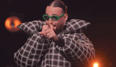 Man In Plaid Jacket And Green Glasses Holding Microphone GIF