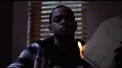 Man In Plaid Jacket Lighting Paper With Match GIF