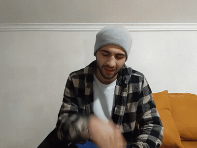 Man in Plaid Shirt and Beanie Upside Down Smiling
