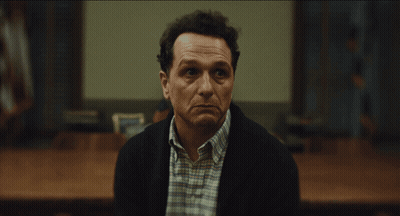 Man In Plaid Shirt And Black Jacket Facing Camera GIF