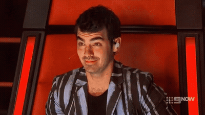 Man In Plaid Shirt And Black Jacket With #Ama5 Hashtag GIF