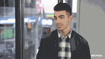 Man In Plaid Shirt And Black Jacket With Hashtag #Ama5 GIF