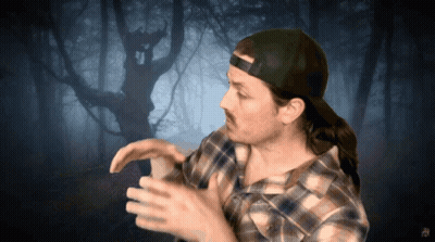 Man In Plaid Shirt And Cap In Front Of Tree GIF