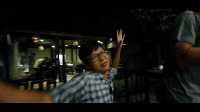 Man In Plaid Shirt And Glasses Dancing In Dark Room GIF