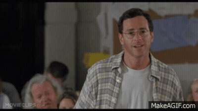 Man In Plaid Shirt And Glasses Faces Crowd GIF