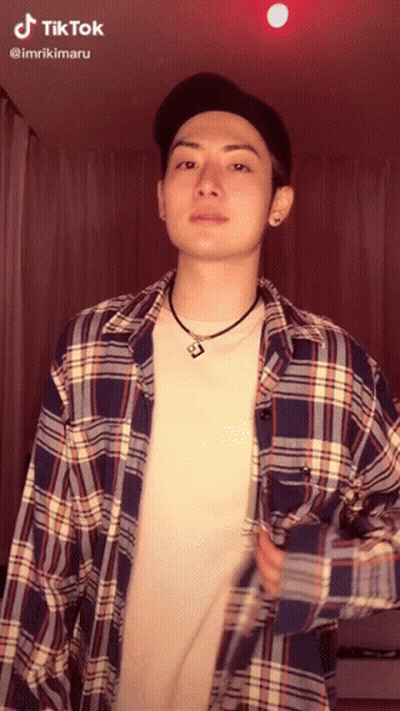 Man In Plaid Shirt And Hat With TikTok Sticker On Face GIF
