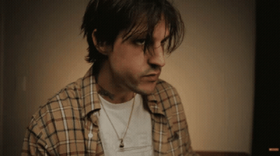 Man In Plaid Shirt And Necklace With I Love You Tattoo GIF