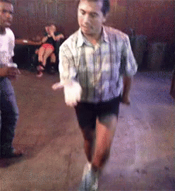 Man In Plaid Shirt And Shorts Dancing In Club GIF