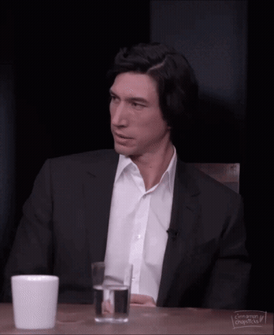 Man In Plaid Shirt And Suspenders Looking Over Shoulder GIF