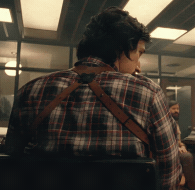 Man In Plaid Shirt And Suspenders Looking Over Shoulder GIF