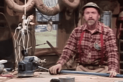 Man In Plaid Shirt And Suspenders Working On Pipe GIF