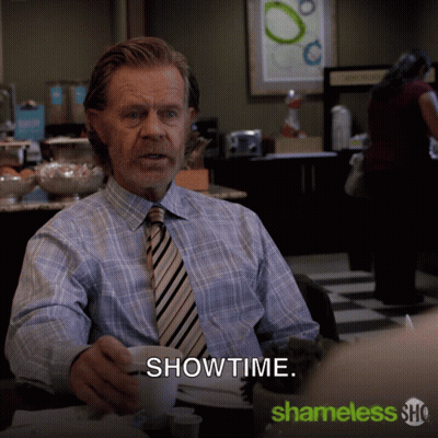 Man In Plaid Shirt And Tie At Table With Showtime GIF