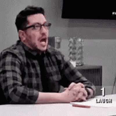 Man In Plaid Shirt And Tie Sitting With Hands Folded GIF